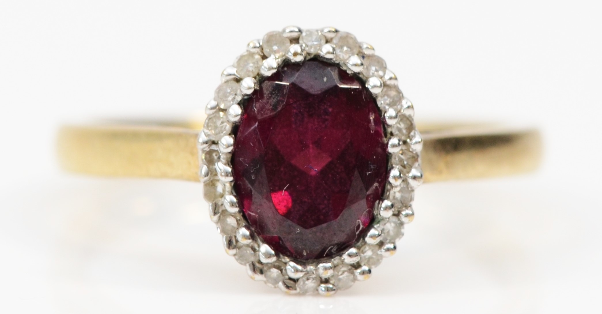 A 9ct gold garnet and diamond cluster ring, 10 x 8mm, O, 2.1gm