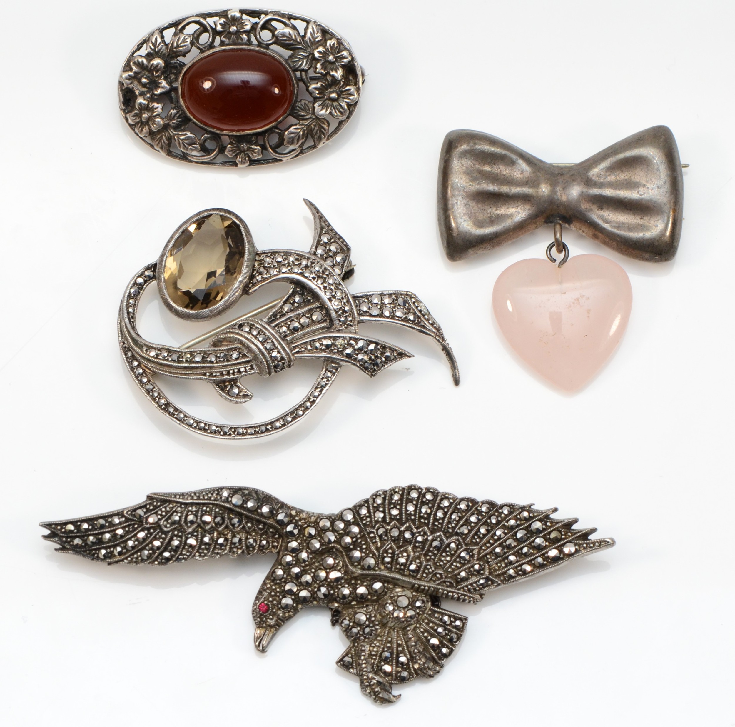 A silver and marcasite eagle brooch, Birmingham 1947, 80mm and three other brooches, 49gm