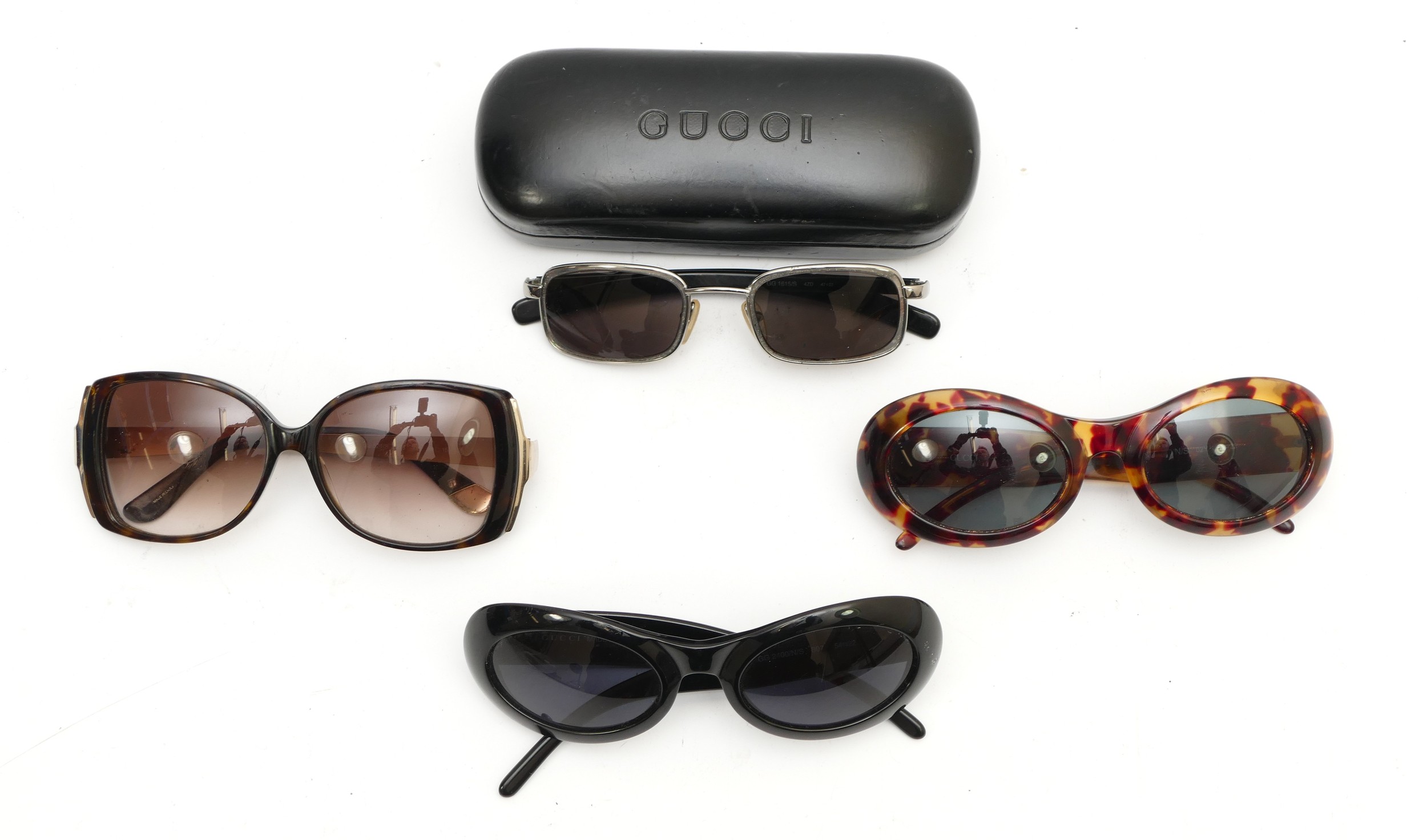 Four pairs of designer sunglasses, comprising of three pairs of Gucci sunglasses, to include, a pair