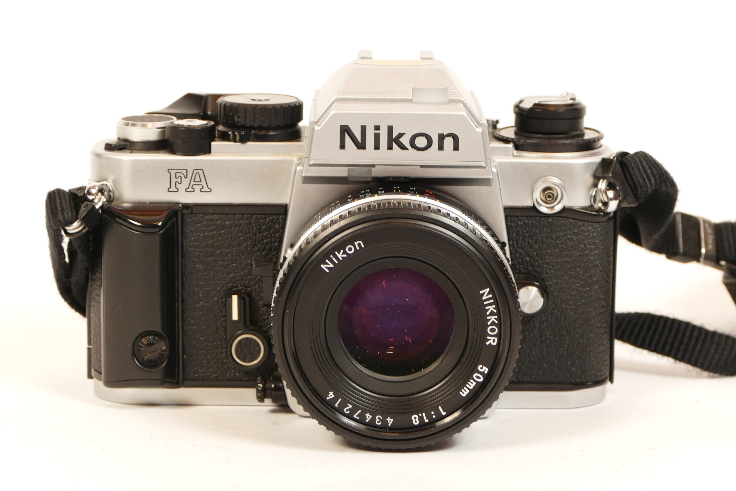 A Nikon FA camera, in chrome finish, with 50mm f/1.8 Nikon Ais Pancake lens, cap, strap