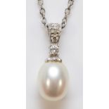 A 9ct white gold diamond and cultured pearl pendant with a chain, 20mm total pendant length, 3.4g