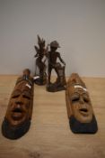 Two carved treen tribal masks and two finely carved figurines.