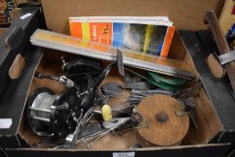 A small selection of fishing equipment including reels and weights etc.