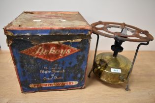 A vintage Optimus Svea camping stove and an enamelled Askeys biscuit tin