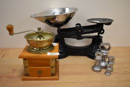 A vintage pine coffee grinder, 18cm tall, together with a set of enamelled black kitchen scales with
