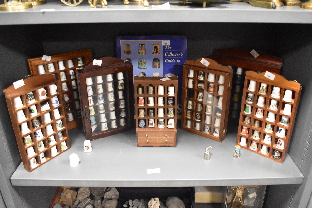 Seven display cases housing a variety of collectable thimbles, also included is a collectors guide.
