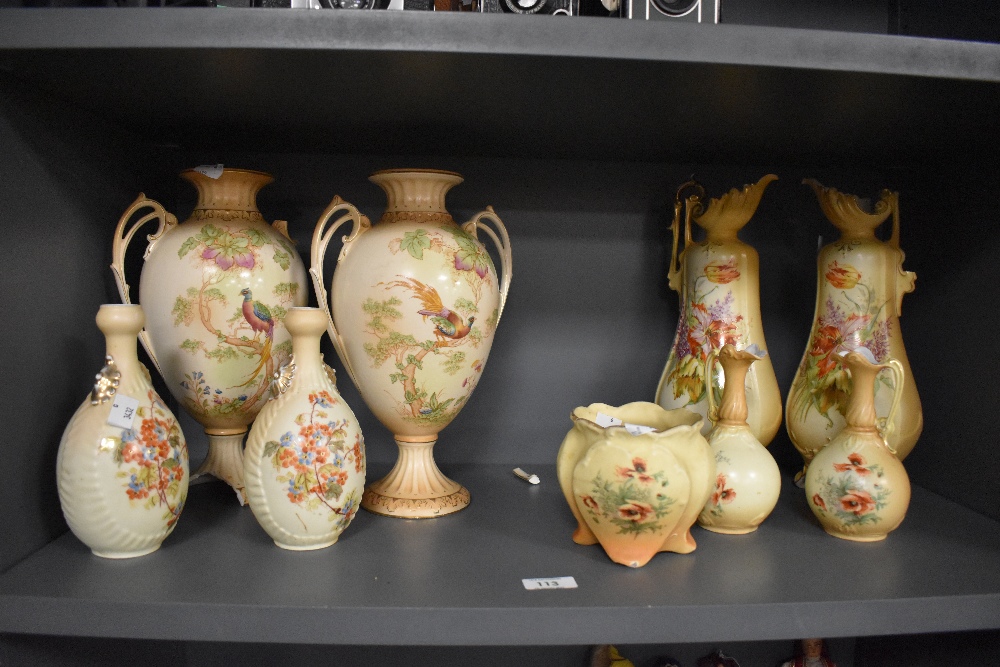 An assorted collection of Royal Worcester style vases on blush ivory ground, and with hand painted