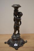 A 20th century silver plated candlestick, depicting cherub and having moulded foot.