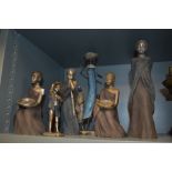 A collection of Soul Journeys figurines, depicting African children and females.