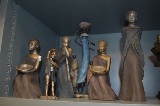 A collection of Soul Journeys figurines, depicting African children and females.