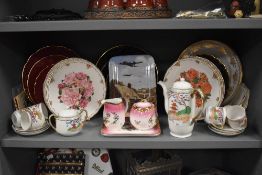 An assortment of decorative ceramics, including plates and a Japanese tea set.