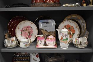 An assortment of decorative ceramics, including plates and a Japanese tea set.