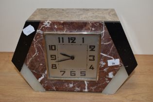 An Art Deco mantle clock oconstructed with varying shades of marble.