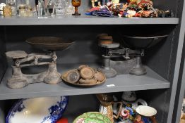 Two sets of 19th Century cast iron weighing scales with weights, the largest measures 22cm x 28cm