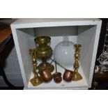 An assorted collection of brass and copperware, including an early 20th Century oil lamp with shade,