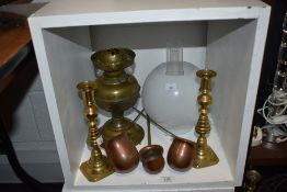 An assorted collection of brass and copperware, including an early 20th Century oil lamp with shade,