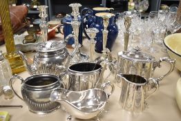 A selection of plated ware, including candlesticks, etched teapot, jug and sugar basin, gravy boat