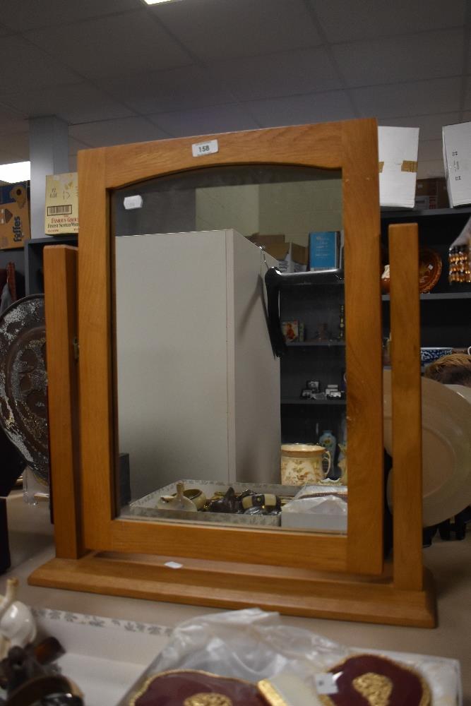 A modern oak rectangular dressing table mirror, measuring 54cm x 62cm overall