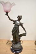 A vintage cast spelter table lamp with pink shade, in the form of a classically attired maiden