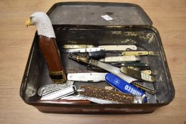 An assorted collection of vintage and novelty folding knives, including a Tonerini horn handled