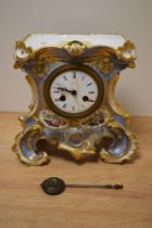 An early Victorian ceramic clock, having extensive gilt detailing with hand painted florals and