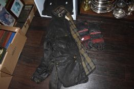 A waxed cloth Belstaff Trialmaster jacket, trousers and a pair of gloves