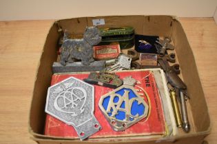 A selection of vintage items, including West Highland terrier car mascot, AA and RAC badges, tyre