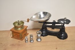 A vintage pine coffee grinder, 18cm tall, together with a set of enamelled black kitchen scales with