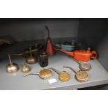 A collection of vintage oil cans and oil drippers.