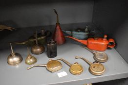 A collection of vintage oil cans and oil drippers.