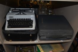 A vintage Erika typewriter, and another by Olympia, both cased