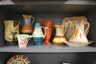 A selection of bright Art Deco hand painted Myott pottery, including jugs, plate and vases.