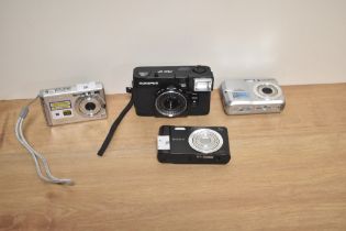 A group of assorted vintage digital cameras, comprising an Olympus Pen EF camera, a Samsung S760