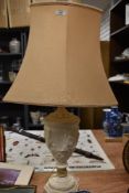 A 20th Century resin urn form table lamp decorated with a classical design, with shade, measuring