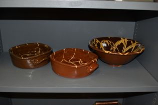 Three items of drip glazed terracotta, including bowl and two casserole dishes, in the manner of