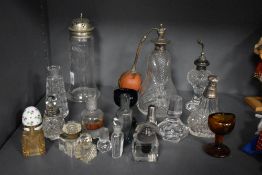 An Edwardian glass sugar castor with white metal lid, two cut glass atomisers, and an assorted