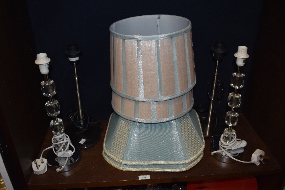 Two pairs of modern table lamps, to include a pair of Next faceted glass lamps, with shades, 50cm