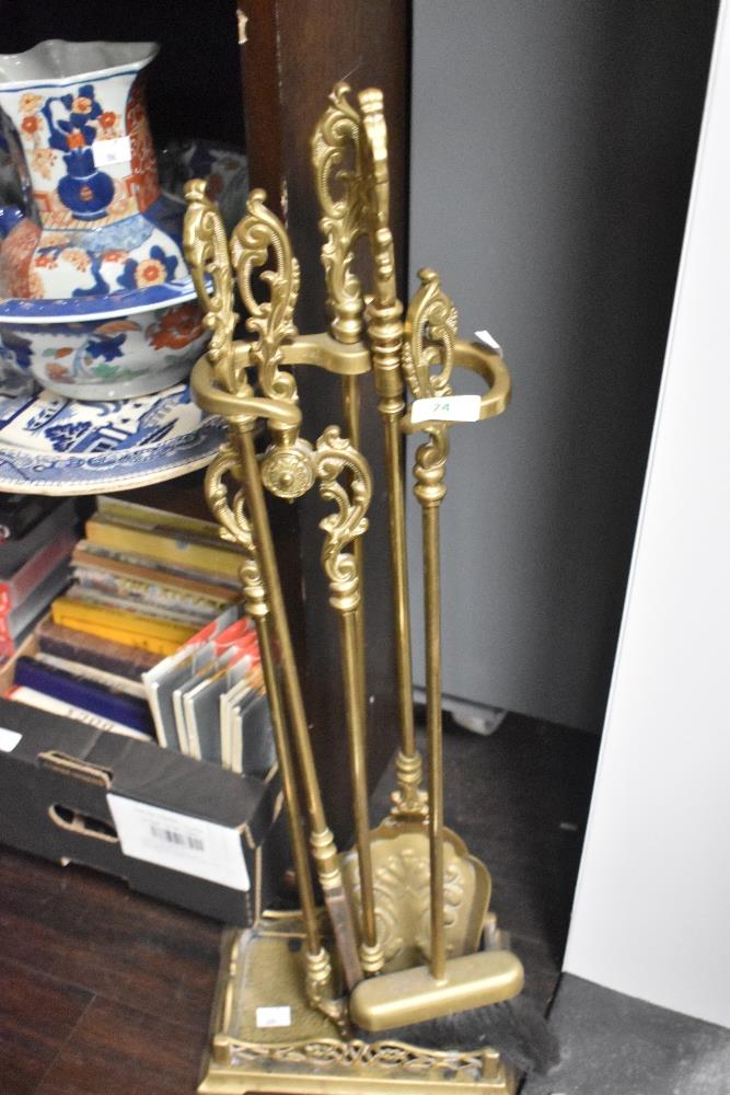 A vintage brass fire companion set, comprising; stand with brush, shovel, poker and tongs.