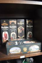 Five vintage Glenfiddich Scotch whisky tins.