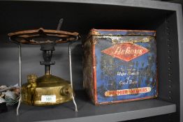 A vintage Optimus Svea camping stove and an enamelled Askeys biscuit tin