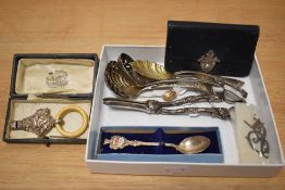 A hallmarked silver babies rattle with whistle, having impressed bird and flower decoration and