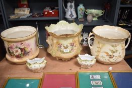 Three early 20th century planters, two having bird decoration and flowers, the other with floral