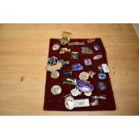 A collection of vintage enamelled badges, including a National Benzole Mixture promotional lapel