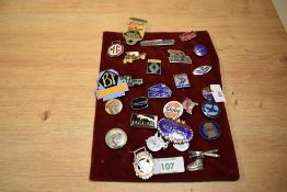 A collection of vintage enamelled badges, including a National Benzole Mixture promotional lapel