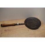 A 19th Century cooking sieve, possibly Middle Eastern, with turned wooden handle, and measuring 70cm