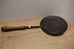 A 19th Century cooking sieve, possibly Middle Eastern, with turned wooden handle, and measuring 70cm