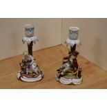 A pair of late 19th/early 20th century Sitzendorf porcelain figural candlesticks, one ornamented