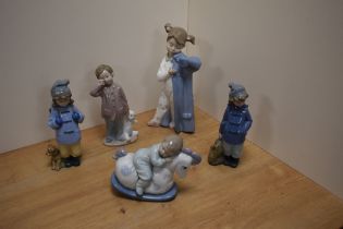 A group of five Nao by Lladro porcelain figures and figurines, two dressed in hiking or outdoor