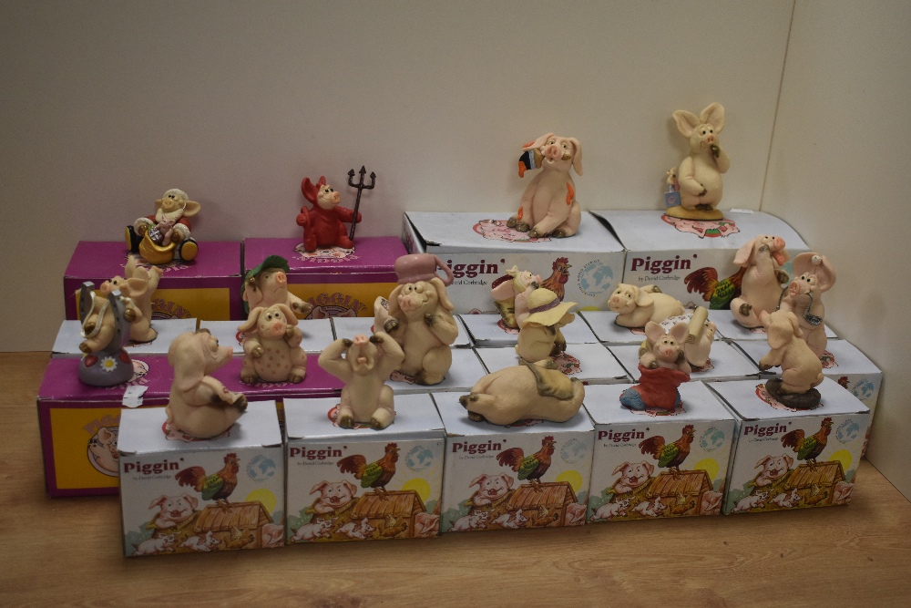 A collection of twenty two 'Piggin' Collectible World Studios comical/anthropomorphic pig figures,