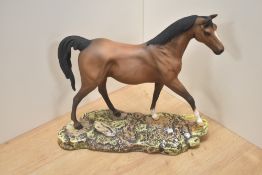 A Royal Doulton bone china race horse study, modelled on a naturalistic base, 29cm high.